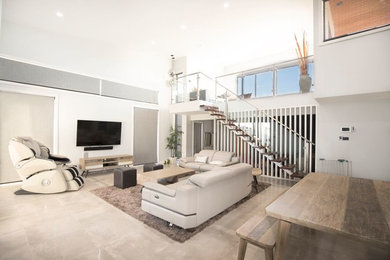 This is an example of a mid-sized contemporary open concept living room in Canberra - Queanbeyan with white walls, marble floors, no fireplace, a wall-mounted tv and white floor.