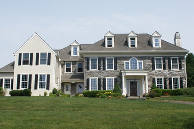 Example of a large minimalist multicolored three-story mixed siding house exterior design in Philadelphia with a hip roof and a shingle roof
