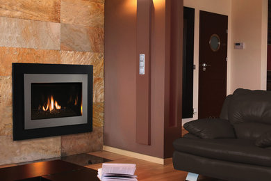 Inspiration for a contemporary living room remodel in Orange County with a standard fireplace and a metal fireplace