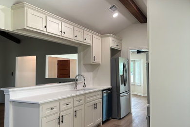 Inspiration for a huge contemporary brown floor and exposed beam dedicated laundry room remodel in Dallas with an undermount sink, quartz countertops, white walls, a side-by-side washer/dryer and white countertops