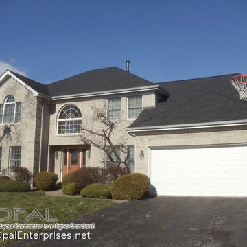 Gray Brick House, GAF Timberline HD Charcoal Shingle Roof and a Wood Front Door