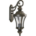 Progress Lighting - 3-Light Wall Lantern, Forged Bronze - Scrolling cast arms, fluted bodies and acorn accents. Clear seeded glass compliments this cast aluminum and brass constructed three-light wall lantern.