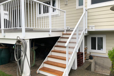 Deck - mid-sized modern backyard deck idea in Vancouver with a roof extension