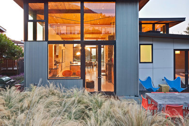 Design ideas for a large beach style two-storey grey exterior in San Francisco with metal siding and a flat roof.