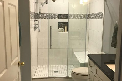 Design ideas for a small contemporary family bathroom in DC Metro with shaker cabinets, white cabinets, a corner shower, a two-piece toilet, white tiles, porcelain tiles, porcelain flooring, a submerged sink, engineered stone worktops, white floors, a sliding door, black worktops and grey walls.