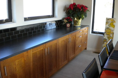 Example of a large minimalist u-shaped concrete floor open concept kitchen design in DC Metro with a double-bowl sink, shaker cabinets, medium tone wood cabinets, concrete countertops, black backsplash, stainless steel appliances and a peninsula