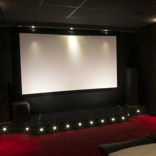 Mid-sized elegant enclosed carpeted home theater photo in Dijon with a projector screen
