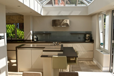 This is an example of a contemporary kitchen in Other with an island.