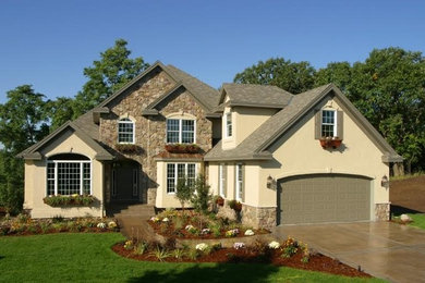 Mid-sized elegant beige two-story mixed siding gable roof photo in Austin