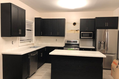 Black Kitchen Cabinets and Quartz Countertops installed by Granite Nations Inc.