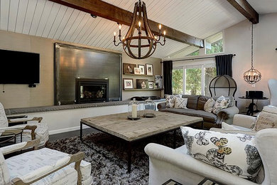 Design ideas for a large transitional open concept living room in Seattle with grey walls, laminate floors, a standard fireplace, a metal fireplace surround, a wall-mounted tv and grey floor.