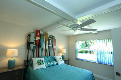 Photo of a mid-sized beach style guest bedroom in Miami with ceramic floors and beige walls.