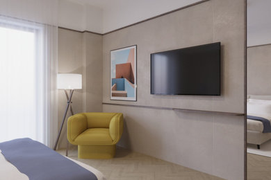 Modelo de dormitorio principal y televisión contemporáneo de tamaño medio con suelo de madera clara y boiserie