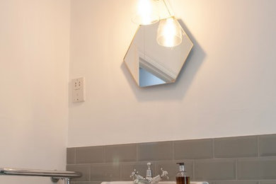 Inspiration for a classic bathroom in London with green tiles, ceramic tiles, white walls and a pedestal sink.