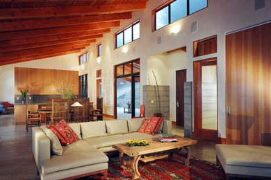 Trendy open concept concrete floor and gray floor family room photo in San Francisco with white walls