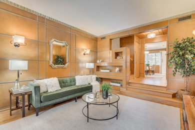 Living room - mid-sized 1950s formal and enclosed medium tone wood floor and wall paneling living room idea in DC Metro with brown walls and a corner fireplace