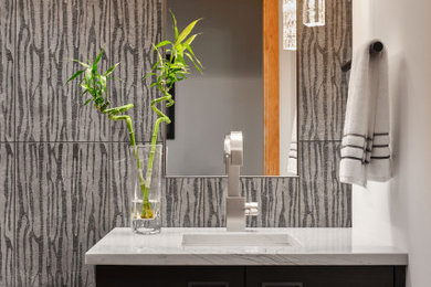Example of a mid-sized trendy powder room design in Denver with flat-panel cabinets, black cabinets, white walls, quartzite countertops, white countertops and a built-in vanity