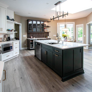 3 Finishes on Kitchen Cabinetry with Galley Workstation in Island and Wine Bar