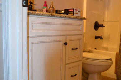 Elegant beige tile bathroom photo in Birmingham with an undermount sink, recessed-panel cabinets, white cabinets, granite countertops and beige walls