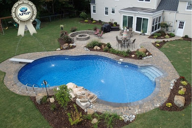 Pool fountain - mid-sized contemporary backyard stone and custom-shaped pool fountain idea in Other