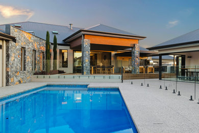 Inspiration for an expansive country backyard rectangular pool in Perth with a pool house and concrete slab.
