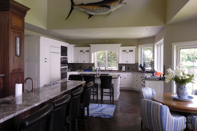 Inspiration for a mid-sized timeless dark wood floor open concept kitchen remodel in Grand Rapids with beaded inset cabinets, white cabinets, stainless steel appliances and an island