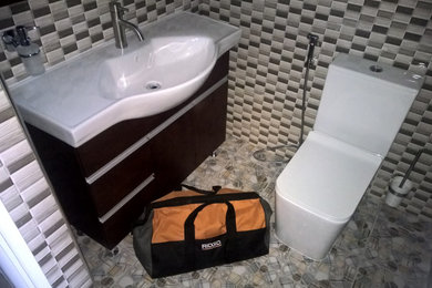 Bathroom - large modern 3/4 multicolored tile and ceramic tile ceramic tile, multicolored floor, single-sink and brick wall bathroom idea with flat-panel cabinets, brown cabinets, a two-piece toilet, a drop-in sink and a freestanding vanity