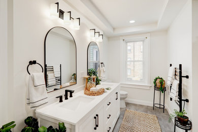 Inspiration for a mid-sized contemporary master vinyl floor, gray floor and double-sink bathroom remodel in Other with recessed-panel cabinets, white cabinets, a two-piece toilet, white walls, an integrated sink, quartz countertops, white countertops and a built-in vanity