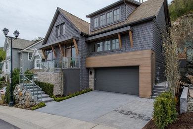 Large arts and crafts gray two-story mixed siding exterior home photo in Vancouver with a hip roof