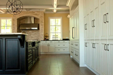 Eat-in kitchen - large transitional l-shaped porcelain tile eat-in kitchen idea in Detroit with an undermount sink, shaker cabinets, white cabinets, granite countertops, black backsplash, stone slab backsplash, stainless steel appliances and an island