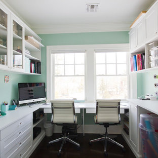 Inspiration for a contemporary craft room in New York with green walls, dark hardwood floors and a built-in desk.