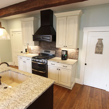 Painted Cream with Brown Glaze Cabinets with Giallo Granite Countertops ~ Sevill