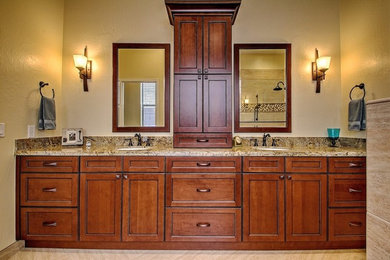 Inspiration for a large timeless master beige tile and ceramic tile ceramic tile alcove shower remodel in Phoenix with recessed-panel cabinets, medium tone wood cabinets, beige walls, an undermount sink and granite countertops