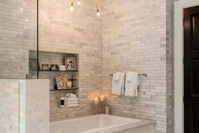 This is an example of a large traditional master bathroom in Baltimore with a corner tub, a corner shower, gray tile, white tile, stone tile, white walls and marble floors.