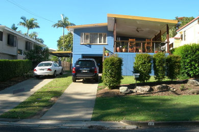 This is an example of a beach style two-storey blue exterior in Brisbane with wood siding and a gable roof.