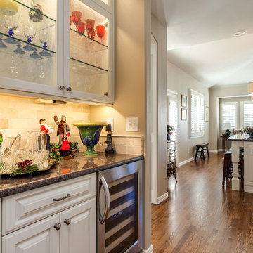 Adjoining butlers pantry with open shelving and wine refrigerator