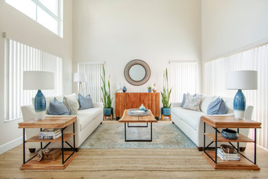 Inspiration for a coastal vinyl floor living room remodel in Other with beige walls