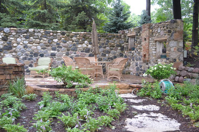 Large mountain style front yard concrete patio photo in Milwaukee with a fire pit and no cover