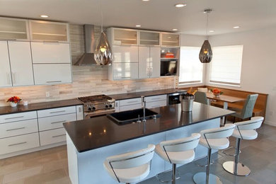 Mid-sized trendy single-wall concrete floor kitchen photo in Other with a farmhouse sink, flat-panel cabinets, white cabinets, quartz countertops, white backsplash, marble backsplash and stainless steel appliances