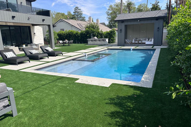 Mid-sized trendy backyard concrete and rectangular lap hot tub photo in Los Angeles