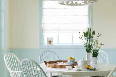 Beach style white floor dining room photo in Los Angeles with beige walls