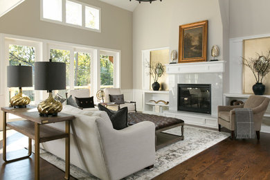 Design ideas for a large transitional formal open concept living room in Kansas City with grey walls, medium hardwood floors, a standard fireplace, a stone fireplace surround, no tv and brown floor.