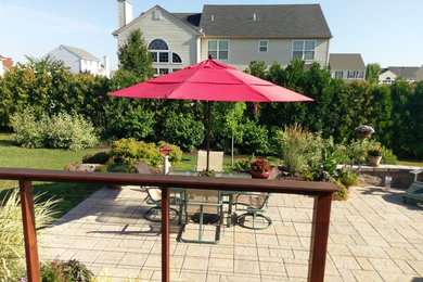 Patio - mid-sized traditional backyard concrete paver patio idea in Philadelphia with no cover