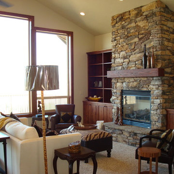Living room with stone fireplace that stretches to ceiling