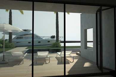 Example of a mid-sized trendy backyard rectangular infinity pool fountain design in Other with decking