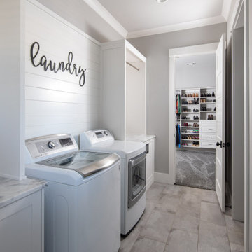 Laundry Room with Shiplap Sign Wall and Side-by-Side Machines