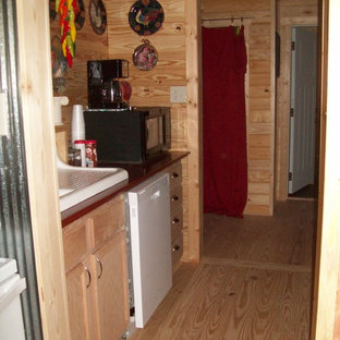 Mid-sized farmhouse kitchen pantry photos - Kitchen pantry - mid-sized country l-shaped light wood floor kitchen pantry idea in Jackson with a farmhouse sink, green cabinets, wood countertops and white appliances