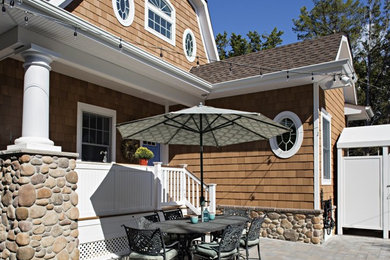 Inspiration for a coastal beige two-story concrete fiberboard exterior home remodel in Philadelphia with a clipped gable roof