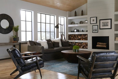 Living room - mid-sized mid-century modern formal and open concept light wood floor living room idea in Seattle with white walls, a standard fireplace, a wood fireplace surround and no tv