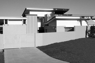 Photo of a modern home design in Newcastle - Maitland.